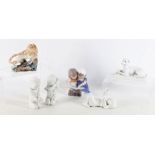 A collection of figures of animals and children, including a glazed pottery model of a lion, a