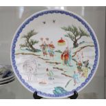 A late Qing enamlled plate, decorated with a landscape scene incorporating figures and elephants (