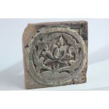 A large square form Chinese pottery tile, with lotus flower decoration within a central medallion,