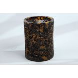 A Chinese carved and pierced tortoiseshell brush pot, 12cm high x 9cm diameter.