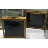 A pair of giltwood wall mounting display cabinets, having carved pediments, glazed sides and