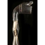 A FOLK ART SEGMENTED HORN WALKING STICK. The handle carved as a fist with metal fingernails, the