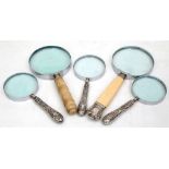 Three hallmarked silver handled magnifying glasses, and one bone and one ivory handled example,