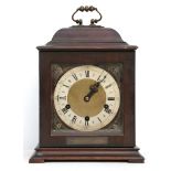 A presentation mantle clock, mahogany case, brass cherub spandrils, Roman numerals to chapter