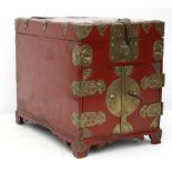 An early 20th century, Chinese export red lacquer travelling cabinet with foliate chased brass