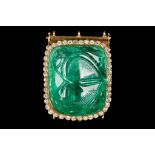 An 18 carat yellow gold, emerald and diamond clasp, set with an impressive carved emerald of approx.