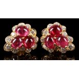 A pair of 18 carat yellow gold, diamond, and ruby ear studs of trefoil form, each set three