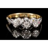 An 18 carat yellow gold and three stone diamond ring. Size: M Weight, 3.4g