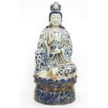 A large contemporary ceramic statue of Yuan Yin, holding a vase, seated on a lotus leaf, blue and