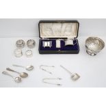 Regency style 3 piece silver condiment set, other silver cutlery, napkin rings, salts and a repousse