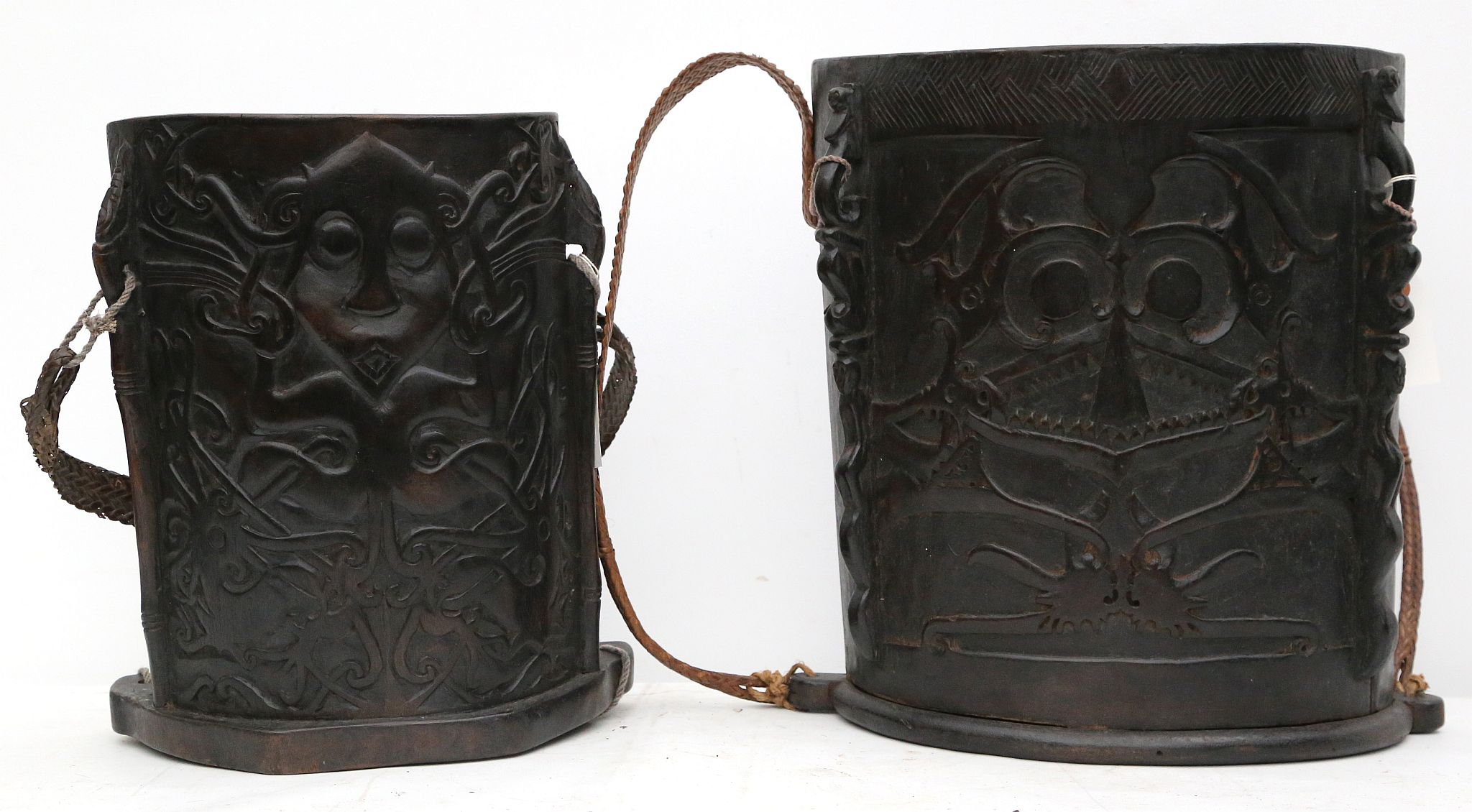 Two decorative Dayak wood back carriers, Indonesia (2).