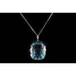 An 18ct white gold and aquamarine pendant, the cushion cut stone being claw set below and diamond
