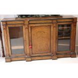 A Victorian burr walnut breakfront credenza, with central panelled door flanked by two glazed doors,