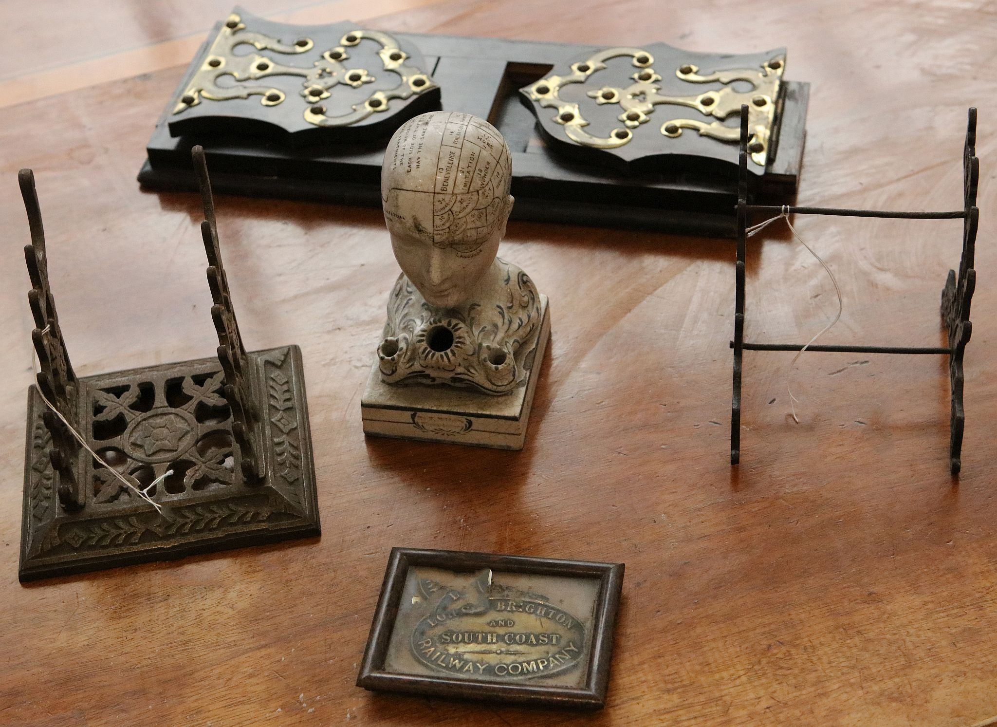 A desk top 19th century phrenology head inkwell by W. Bridge, with further desk items i.e. two metal