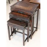 A nest of three Chinese carved wood tables, the tallest 69cm high.