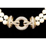 A double strand pearl necklace, having yellow metal and diamond set stylised knot pendant, and 9