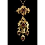 A yellow metal, diamond, and pink topaz Art Nouveau style drop pendant, suspended on an 18 carat