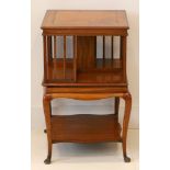 An Edwardian satinwood and crossbanded table mounted revolving bookcase with under shelf, table