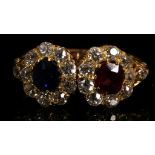 An 18 carat yellow gold, diamond, ruby, and sapphire twin cluster ring, set round cut sapphire of