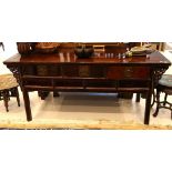 A large Chinese hardwood side table, with three drawers and carved decoration, 194cm wide.