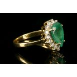 An 18 carat yellow gold, diamond, and emerald cluster ring,  set 2.07 carat pear cut emerald flanked