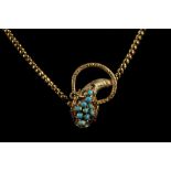 A Victorian yellow metal, turquoise, and ruby snake head pendant, fastening as a clasp, suspended on
