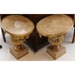A pair of Empire style gilded plant stands, oval 49cm wide top with leaf drops, set on vase stem
