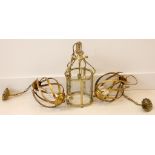 A brass hall lantern, having 6 shaped glass panes, scroll supported, 48cm high, with a pair of