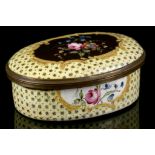 A 19th Century English enamel trinket box, of oval form, having hand painted floral decoration on