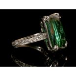 A white metal and green/blue tourmaline ring, set rectangular faceted stone of 8.9 carats, the