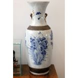 A tall Chinese crackle glazed vase, decorated with flowers and buds and having chased brown