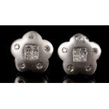 A pair of 18 carat white gold and diamond flower-shaped ear studs, each set four square cut diamonds