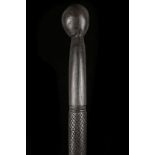 AN ETHNIC EBONY WALKING CANE. With spherical knop and shallow carving to the shaft, 98cm long.