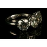 A platinum and three stone diamond ring, set round cut stones of approx. 5.54 carats in total. Size: