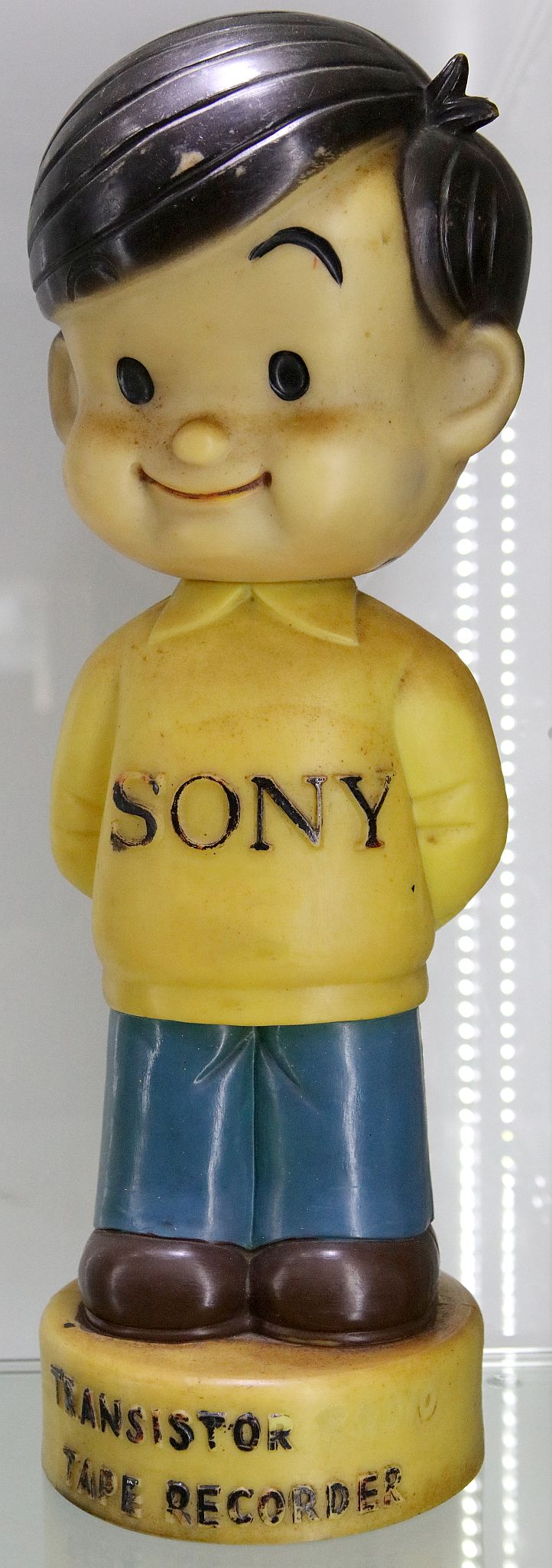 Sony - a shop display of a young boy in yellow T-shirt with the word 'Sony', supported on a circular