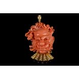 A yellow metal, diamond, and coral pendant / brooch (tests as gold), set ornately carved coral