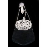 An Art Nouveau period ladies purse, having hallmarked silver top, pierced flowering branch