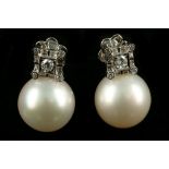 A pair of white gold, diamond, and pearl drop earrings, each having a square mount set with round