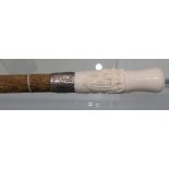 A modern marine Ivory cane, the grip carved with an Oriental mans head over silver collar and Oak