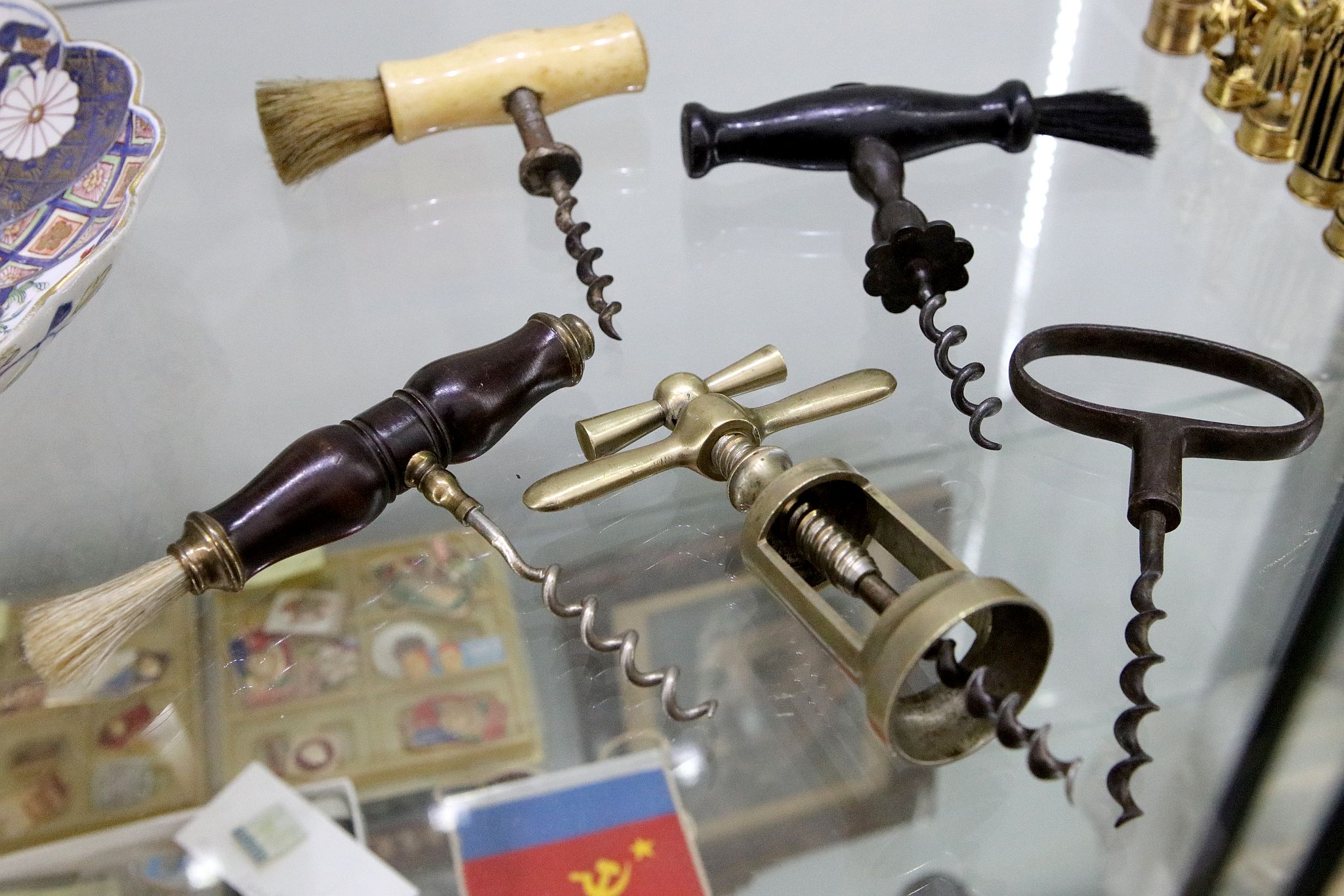 Georgian corkscrews; in ebony, steel and mahogany with brass fittings, a later bone handled