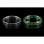 A white metal and square cut emerald eternity ring, together with a white metal and square cut