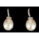A pair of 18 carat yellow gold, diamond, and pearl drop earrings, the mounts pave set with small