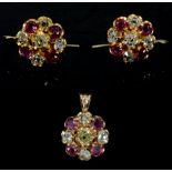 A pair of yellow gold, diamond, and ruby circular cluster earrings, each set with four rubies and