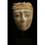 AN EGYPTIAN WOOD SARCOPHAGUS MASK Late Period, circa 664-332 B.C. With added black pupils,