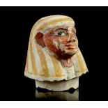 AN EGYPTIAN LIMESTONE CANOPIC JAR STOPPER Late Period, circa 664-332 B.C. Polychrome painted, in the