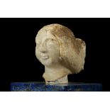 A MESOPOTAMIAN GYPSUM FEMALE HEAD Sumerian, Early Dynastic, circa 2500-2300 B.C. With over-sized