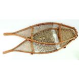 A PAIR OF CREE SNOW SHOES, CANADA Composed of bent wood, woven thread and hide strings, 85cm long (