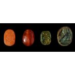 FOUR EGYPTIAN SCARABS AND SCARABOIDS Middle Kingdom - New Kingdom, circa 2133-1070 B.C. Including