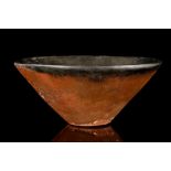 AN EGYPTIAN BLACK-TOPPED POTTERY BOWL Naqada II-III, circa 3200-3000 B.C. With sloping walls and