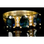 An 18ct gold, sapphire and diamond set ring. Size L.